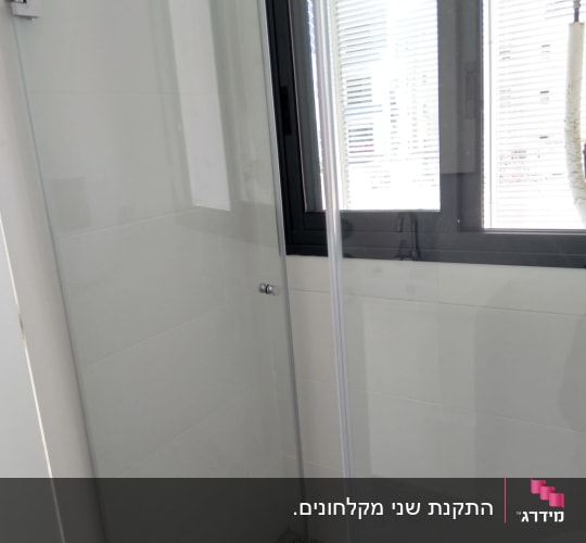 מקלחון זכוכית עם רצפת פסיפס וחלון גדול